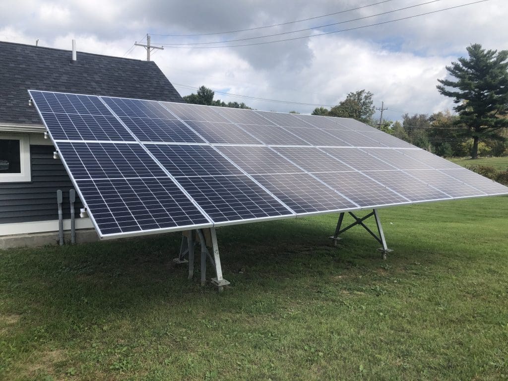Ground-mounted solar array next to the house