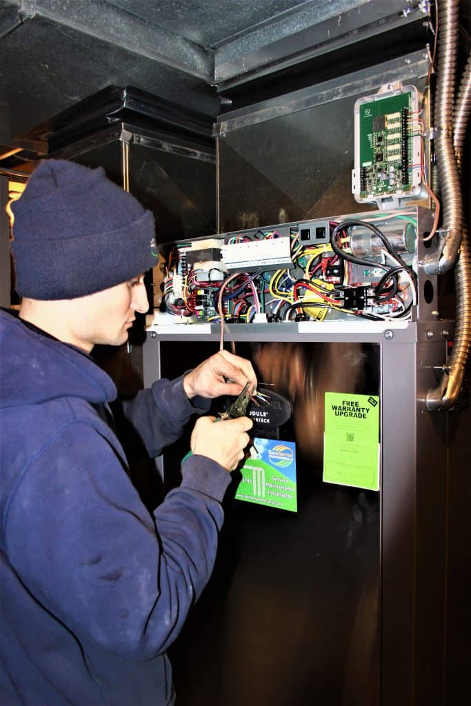 Geothermal Professionals technician servicing an indoor unit