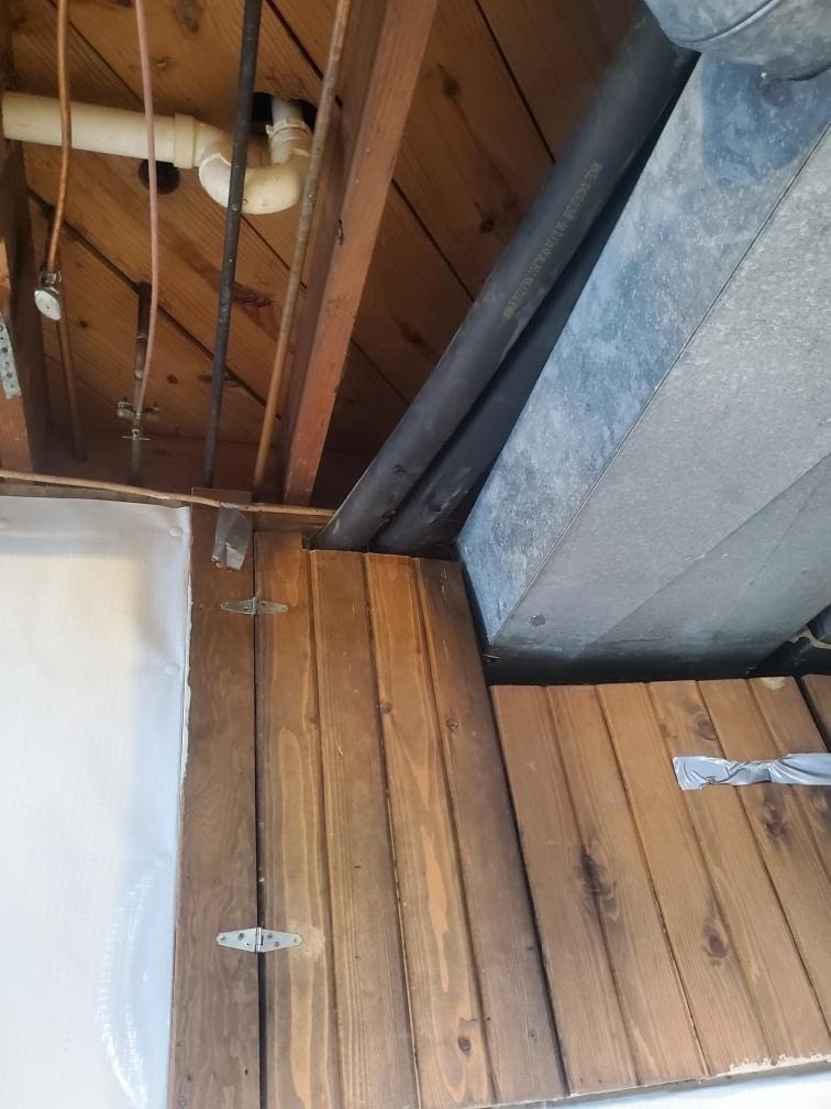 Loop pipe entry point under wood floor